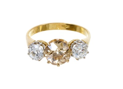 Lot 410 - Diamond three stone ring with a central natural fancy coloured diamond weighing 1.45cts
