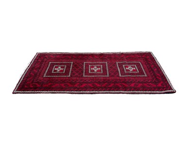 Lot 1369 - Eastern rug with three central medallions on red, black and cream ground, 220cm x 118cm