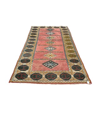 Lot 1376 - Large rug with 7 central medallions on green, pink and yellow ground, 267cm x 137cm