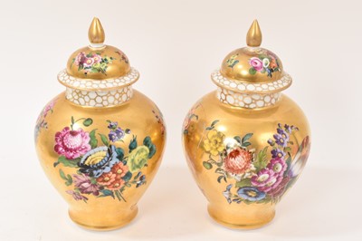 Lot 7 - Pair of Meissen-style porcelain vases and covers, circa 1900, painted with flowers on a gold ground, crossed swords marks, 23.5cm high