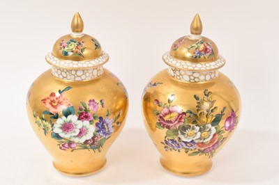 Lot 7 - Pair of Meissen-style porcelain vases and covers, circa 1900, painted with flowers on a gold ground, crossed swords marks, 23.5cm high