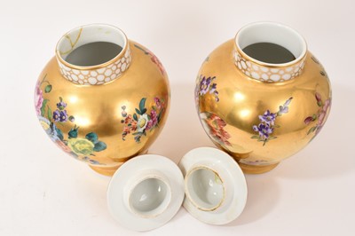 Lot 7 - Pair of Meissen-style porcelain vases and covers, circa 1900, painted with flowers on a gold ground, crossed swords marks, 23.5cm high