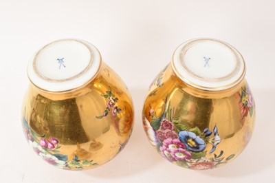 Lot 7 - Pair of Meissen-style porcelain vases and covers, circa 1900, painted with flowers on a gold ground, crossed swords marks, 23.5cm high