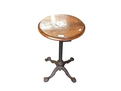 Lot 1382 - Victorian cast iron table base with circular walnut top, 38cm diameter, 64.5cm high