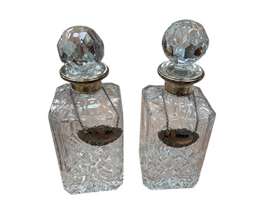 Lot 541 - Pair of contemporary silver mounted cut glass decanters with engraved labels- Port and Whisky.