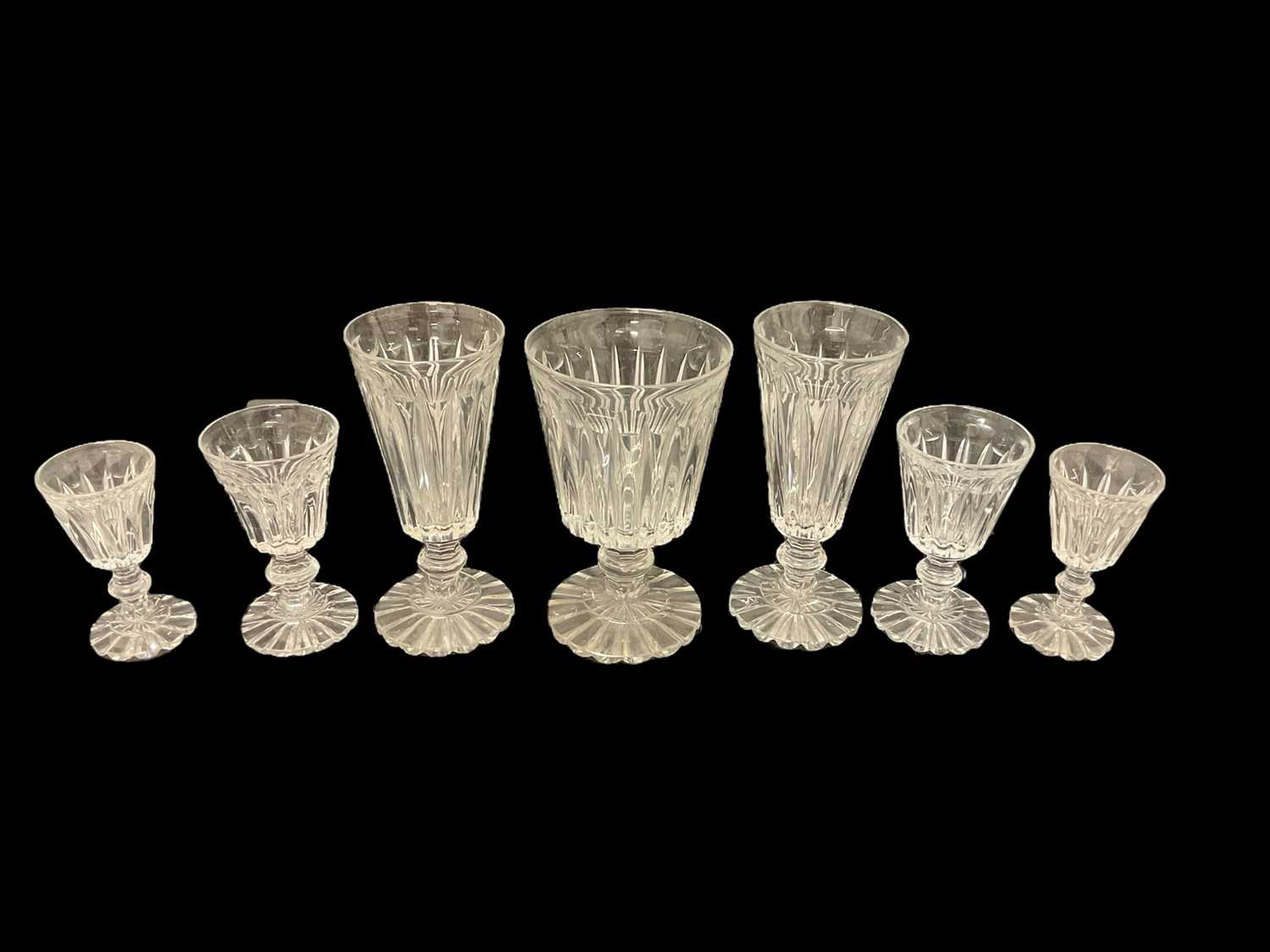 Lot 87 - Victorian glass table service, each drinking glass with tapered fluted bowl on fluted pedestal bases