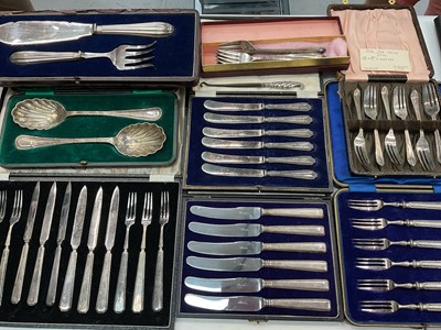Lot 1179 - Two sets of six silver handled butter knives, set of six silver handled cake forks and other plated flatware, mostly in fitted cases