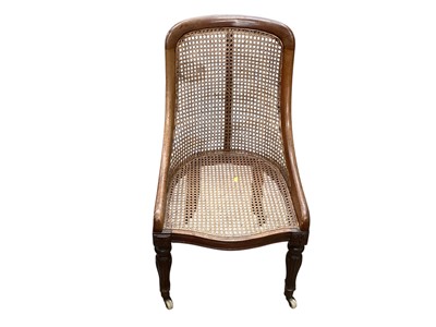 Lot 1427 - Antique mahogany bergere chair on fluted front legs and ceramic castors