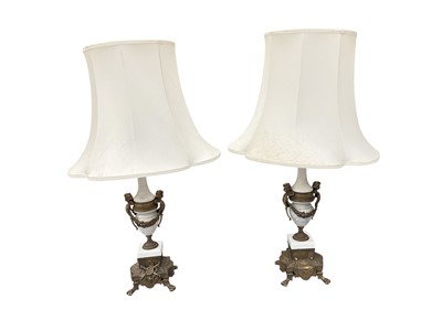 Lot 366 - Pair of marble and brass mounted table lamps with putti and swag decoration, with shades