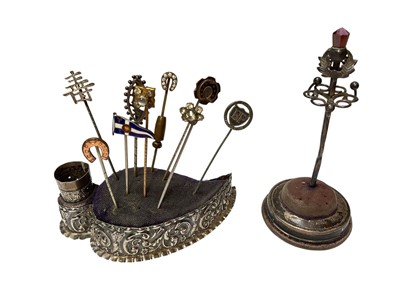 Lot 129 - Two late Victorian/ Edwardian silver pin cushions with a collection of various silver and other stick pins