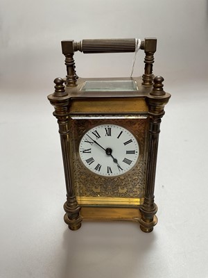 Lot 2407 - Brass cased carriage clock with floral scroll decoration