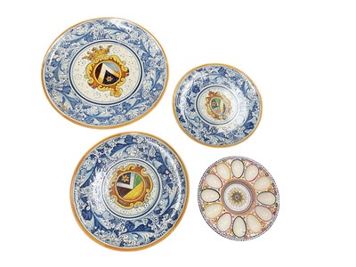 Lot 567 - Graduated set of three Italian pottery chargers, and a similar egg stand, (4).