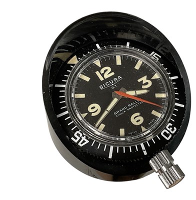 Lot 1960's Sicura GT Grand Rallye shock protected car clock, with button wind movement, rotating bezel, luminous painted hands and hour markers, case 4.7cm in diameter.
