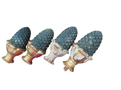 Lot 570 - Group of four matching French giltwood and pineapple finials, (4).