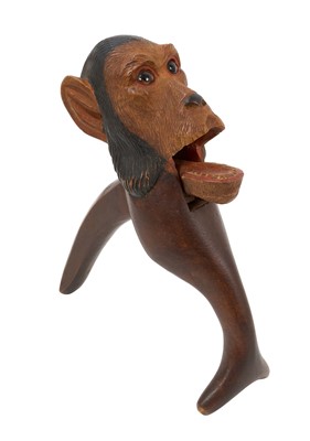 Lot 727 - 19th century Black Forest carved wood novelty nutcracker in the form of a monkey, with glass eyes, approximately 22cm in overall length.