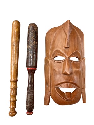 Lot 369 - Victorian turned wood truncheon with painted decoration dated 1854 with ribbed grip, together with another truncheon and an African mask (3)