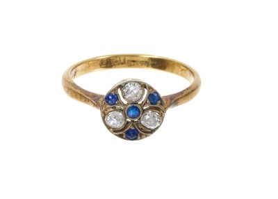 Lot 387 - Edwardian diamond and sapphire cluster ring, the pierced circular plaque with three old cut diamonds and four mixed-cut blue sapphires in platinum millegrain setting on 18ct gold shank