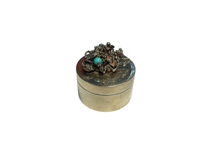 Lot 93 - Contemporary silver circular lidded pill box with abstract design and single turquoise set to the lid