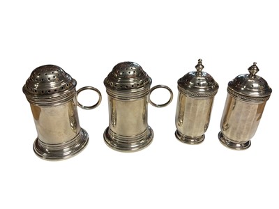 Lot 94 - Pair of silver pepper pots of tankard form, together with another silver pair