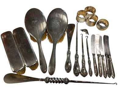 Lot 95 - Four silver mounted dressing table brushes, four various silver napkin rings, five silver handled butter knives and other silver handled items