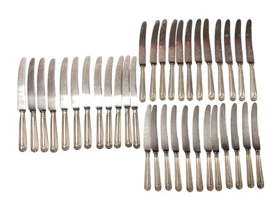 Lot 96 - Set of twelve silver plated shell and thread pattern dinner knives and twenty-four matching dessert knives