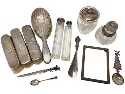 Lot 110 - Silver mounted dressing table brushes, silver mounted glass jars and bottles, silver photograph frame, Dutch white metal spoon etc