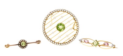 Lot 354 - Edwardian Belle Époque peridot and seed pearl circular plaque brooch and two other Edwardian brooches (3)