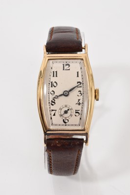 Lot 777 - 1930s 9ct gold wristwatch, the cream dial with black Arabic numerals and subsidiary seconds in a curved 9ct gold tonneau shape case (Glasgow import hallmarks 1934)
