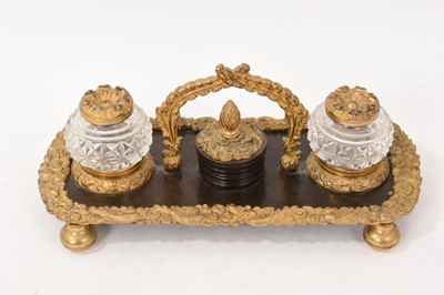 Lot 750 - Regency ormolu mounted bronze desk stand with two pineapple cut glass inkwells