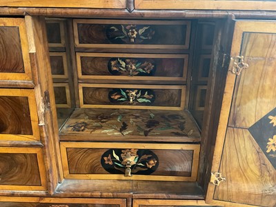 Lot 1432 - Good William & Mary walnut oyster veneered, specimen wood and green stained ivory marquetry inlaid cabinet on later stand, with cushion frieze drawer and fitted interior of drawers about centr...