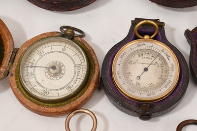 Lot 713 - Nine antique pocket barometers, various makers, including Victorian examples, some in leather cases