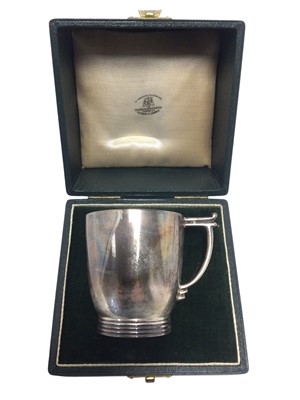Lot 255 - 1940s silver christening mug of tapering form, with angular handle, on a reeded circular base