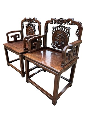Lot 1257 - Pair of early 20th century Chinese hardwood elbow chairs