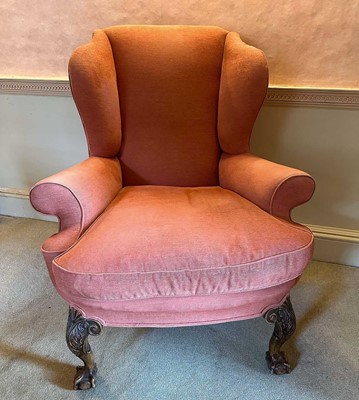 Lot 1386 - Georgian-style wing armchair on substantial carved cabriole legs with claw and ball feet, upholstered in terracotta fabric