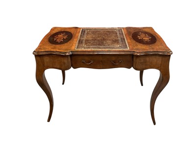 Lot 1458 - 19th century walnut writing table in the French style the top decorated with two oval marquetry panels