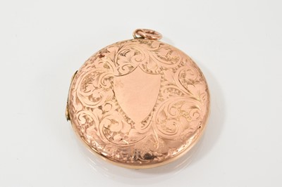 Lot 460 - Edwardian 9ct rose gold (back & front) circular locket with engraved decoration and double compartment to the interior, 35mm