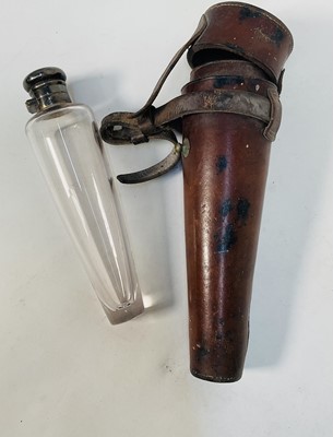 Lot 941 - Vintage leather cased glass saddle flask with silver plated mounts, 23cm long overall