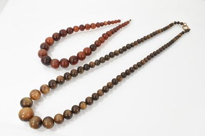 Lot 474 - Two old carved horn bead necklaces, each with graduated spherical beads, the largest 23.5mm diameter.