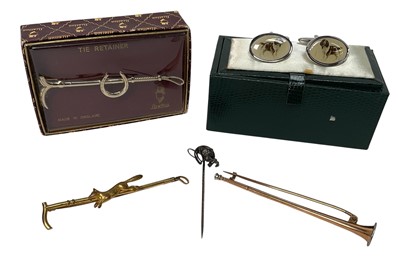 Lot 919 - Edwardian yellow metal stock pin in the form of a hunting horn, another in the form of a hunting whip mounted with a fox, two other pins and a pair of cufflinks (5)