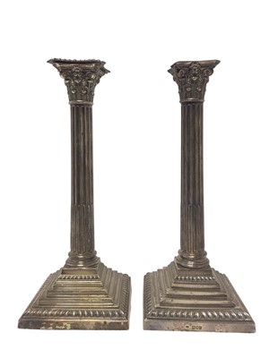 Lot 304 - Pair of late Victorian silver Corinthian column candlesticks, of large size, filled, 36cm high