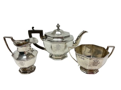 Lot 144 - Edwardian silver three piece octagonal teaset, all with engraved monogram (London 1909)