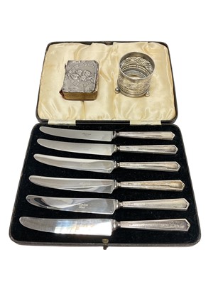 Lot 149 - Set of six 1930s silver handled tea knives in a fitted case, silver salt cellar and a silver mounted miniature book of common prayer.