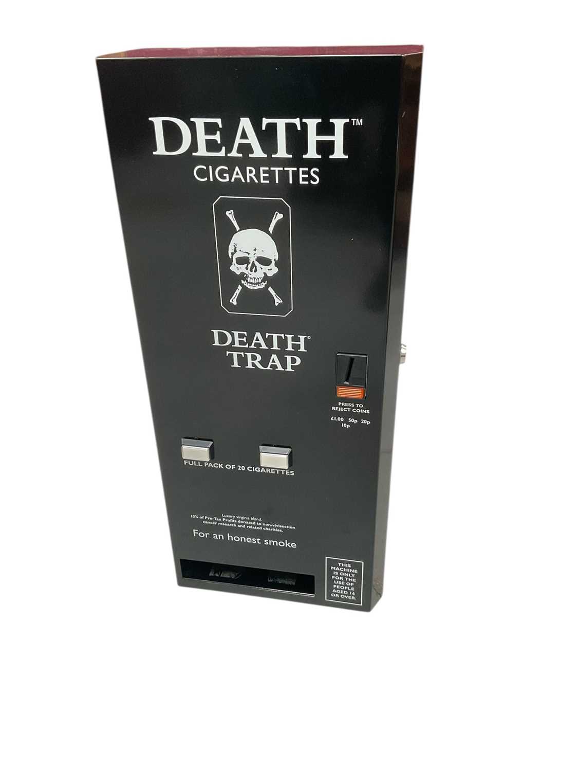 Lot 2459 - 1980s advertising Death Trap cigarette dispenser machine for Death Cigarettes, together with three Death comics