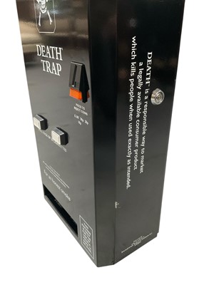 Lot 2459 - 1980s advertising Death Trap cigarette dispenser machine for Death Cigarettes, together with three Death comics