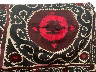 Lot 2110 - Suzani hand embroidered in black and red with central motif. 140 x 130cms approximately.