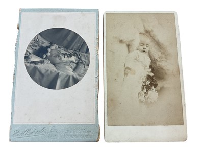 Lot 1420 - Macabre 19th century carte de visite photographs of deceased children, one laid in a silk lined coffin wearing a crown of white roses and with beads and cross resting in hands, the other resting...