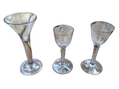 Lot 5157 - 18th century wine or cordial glass, the bowl and stem with facet cut decoration, a similar example with cut flower decoration to bowl and facet cut stem, and one other wine or cordial glass with...