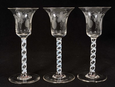 Lot 48 - Set of three opaque twist stem wine or cordial glasses, with engraved flared bowls