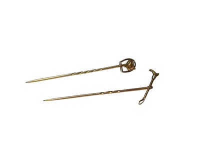 Lot 50 - Two yellow metal hunting stick pins to include one mounted with a fox mask, the other with a riding crop