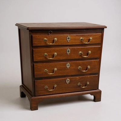 Lot 1322 - A small George III mahogany chest of four drawers with brushing slide